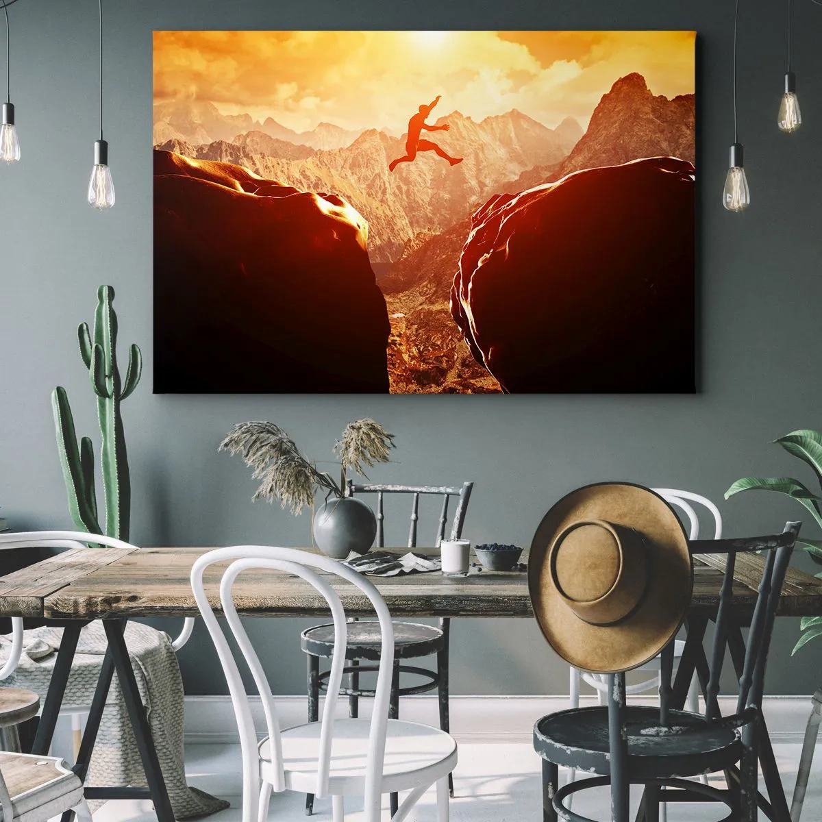 Bild auf Leinwand - Leinwandbild - Eine Figur springt zwischen Felsen mit Bergen im Hintergrund - 120x80cm - Grenzen überschreiten - Moderne Wanddekoration für Wohnzimmer und Schlafzimmer ARTTOR