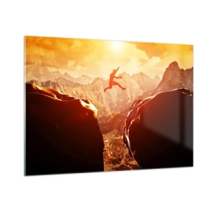 Glasbild - Bild auf glas - Sprung über einen Abgrund in einer Berglandschaft bei Sonnenuntergang - 100x70cm - Grenzen überschreiten - Moderne Wanddekoration für Wohnzimmer und Schlafzimmer ARTTOR