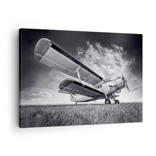 Bild auf Leinwand - Leinwandbild - Ein Flugzeug vor einem dramatischen Himmel in Schwarzweiß - 70x50cm - Der geflügelte Wanderer - Moderne Wanddekoration für Wohnzimmer und Schlafzimmer ARTTOR