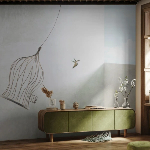 Fototapete Premium Sand - Ein Kolibri im Flug mit einem offenen Käfig gegen den Himmel - 100x70cm - In seinem Element - Moderne Wanddekoration für Wohnzimmer und Schlafzimmer ARTTOR