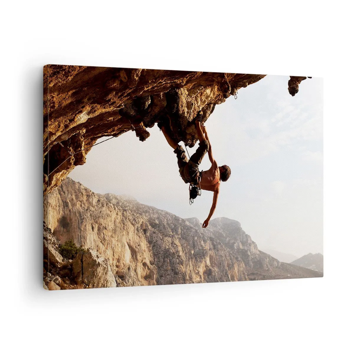 Bild auf Leinwand - Leinwandbild - Ein Kletterer auf einer steilen Klippe in den Bergen im Sonnenschein - 70x50cm - Die Welt ist in einer Hand auf einem Felsblock geschrumpft - Moderne Wanddekoration für Wohnzimmer und Schlafzimmer ARTTOR