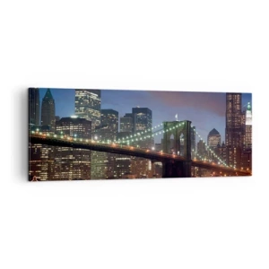 Bild auf Leinwand - Leinwandbild - New York City Bridge bei Nacht mit beleuchteten Gebäuden - 140x50cm - Leuchtende Nacht - Moderne Wanddekoration für Wohnzimmer und Schlafzimmer ARTTOR