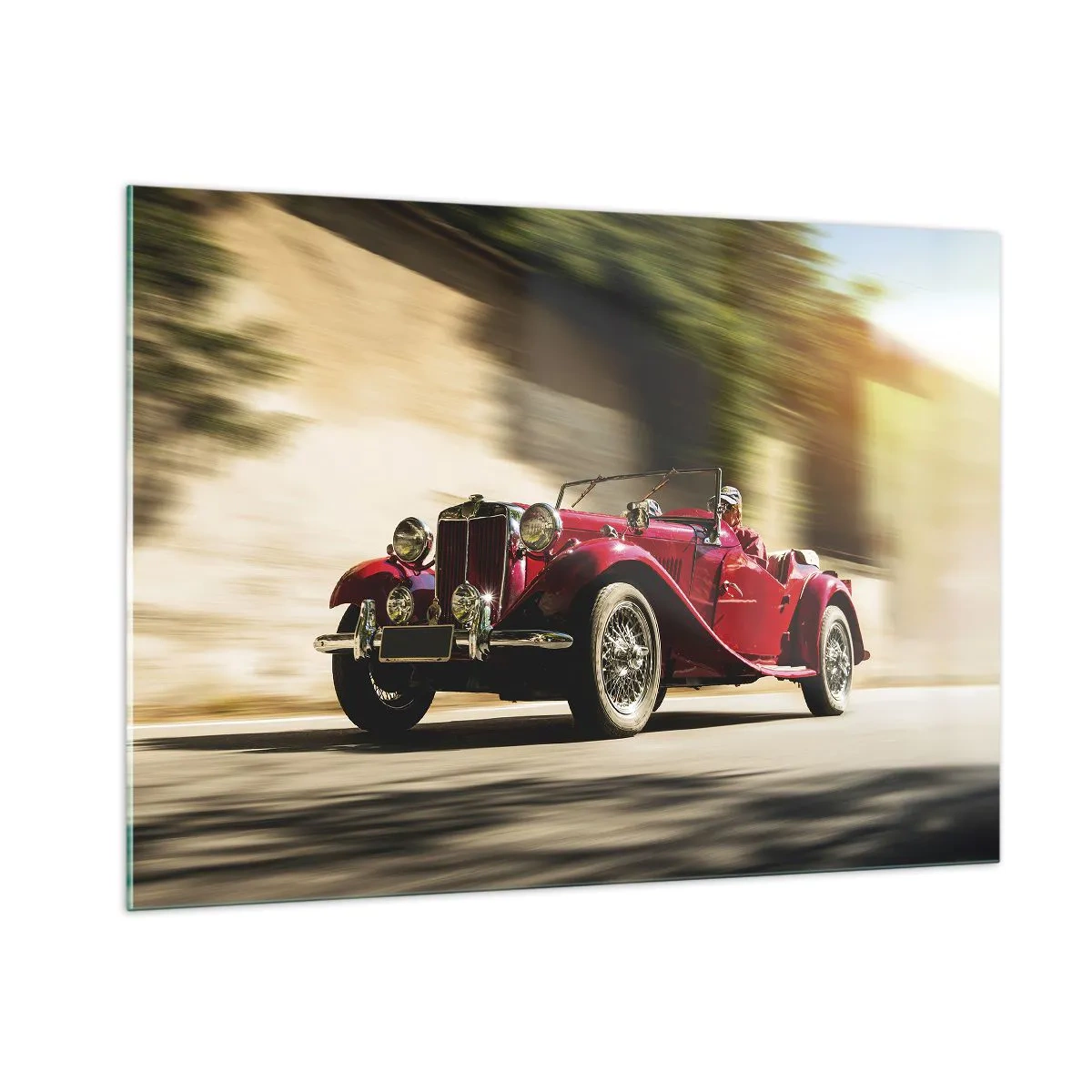 Glasbild - Bild auf glas - Klassisches rotes Cabrio in Bewegung vor dem Hintergrund der Straße und der verschwommenen Landschaft - 100x70cm - Schöner als Nike von Samothrake - Moderne Wanddekoration für Wohnzimmer und Schlafzimmer ARTTOR