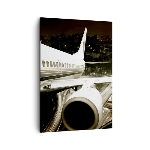 Bild auf Leinwand - Leinwandbild - Ein Flugzeug über einer nächtlichen Stadt mit beleuchteten Autobahnen - 50x70cm - In die Nacht fliegen - Moderne Wanddekoration für Wohnzimmer und Schlafzimmer ARTTOR