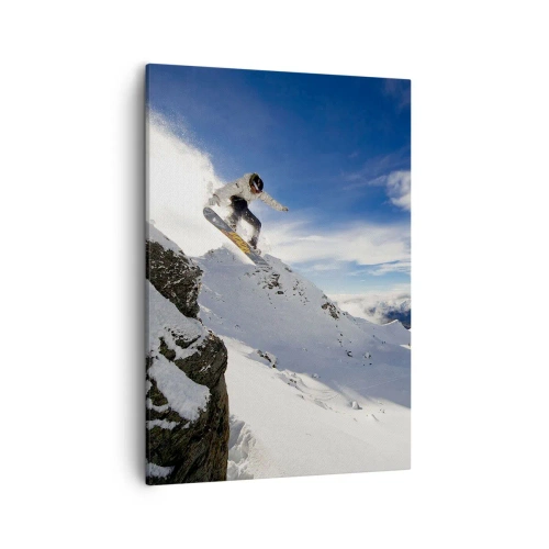 Bild auf Leinwand - Leinwandbild - Ein Snowboarder springt von einer Klippe mit schneebedeckten Bergen im Hintergrund. - 50x70cm - Freiheit ohne Grenzen - Moderne Wanddekoration für Wohnzimmer und Schlafzimmer ARTTOR
