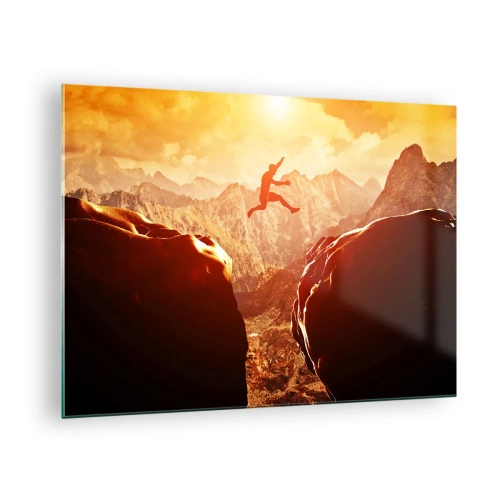 Glasbild - Bild auf glas - Sprung über einen Abgrund in einer Berglandschaft bei Sonnenuntergang - 70x50cm - Grenzen überschreiten - Moderne Wanddekoration für Wohnzimmer und Schlafzimmer ARTTOR