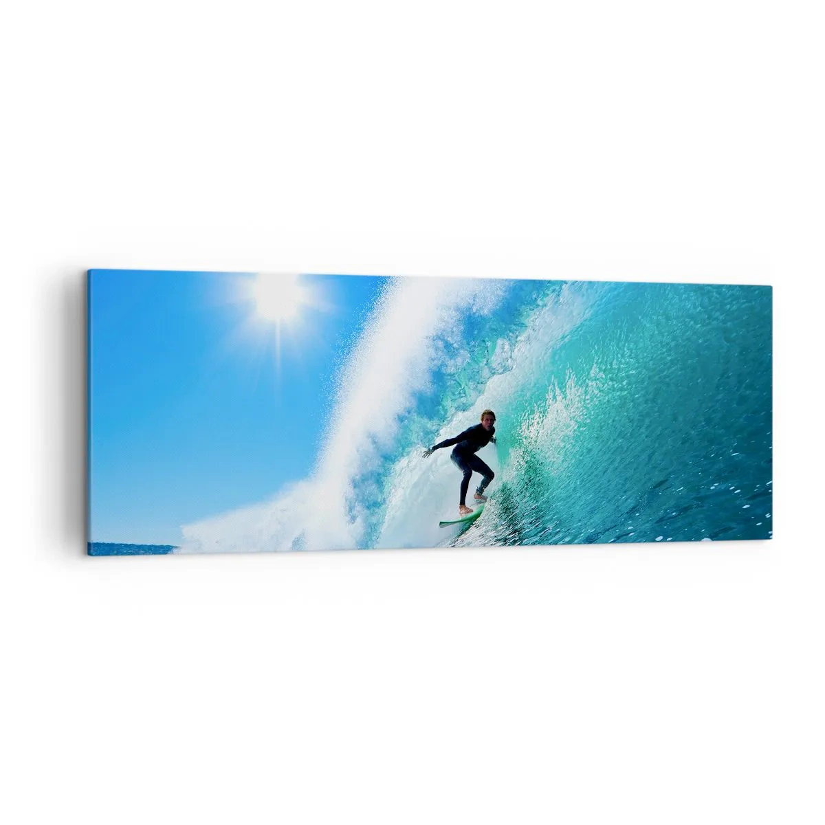 Bild auf Leinwand - Leinwandbild - Ein Surfer auf einem Brett reitet unter blauem Himmel auf einer starken Welle. - 140x50cm - Durch das große Blau - Moderne Wanddekoration für Wohnzimmer und Schlafzimmer ARTTOR