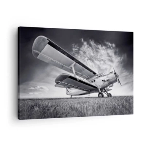Bild auf Leinwand - Leinwandbild - Ein Flugzeug vor einem dramatischen Himmel in Schwarzweiß - 70x50cm - Der geflügelte Wanderer - Moderne Wanddekoration für Wohnzimmer und Schlafzimmer ARTTOR