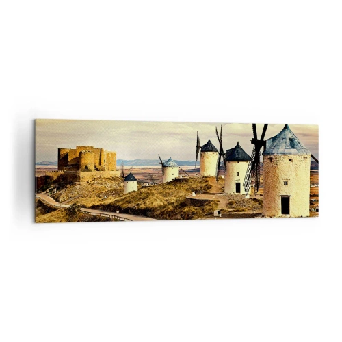 Bild auf Leinwand - Leinwandbild - Windmühlen auf den Hügeln mit einer historischen Burg im Hintergrund - 160x50cm - Don Quijote kommt gleich - Moderne Wanddekoration für Wohnzimmer und Schlafzimmer ARTTOR