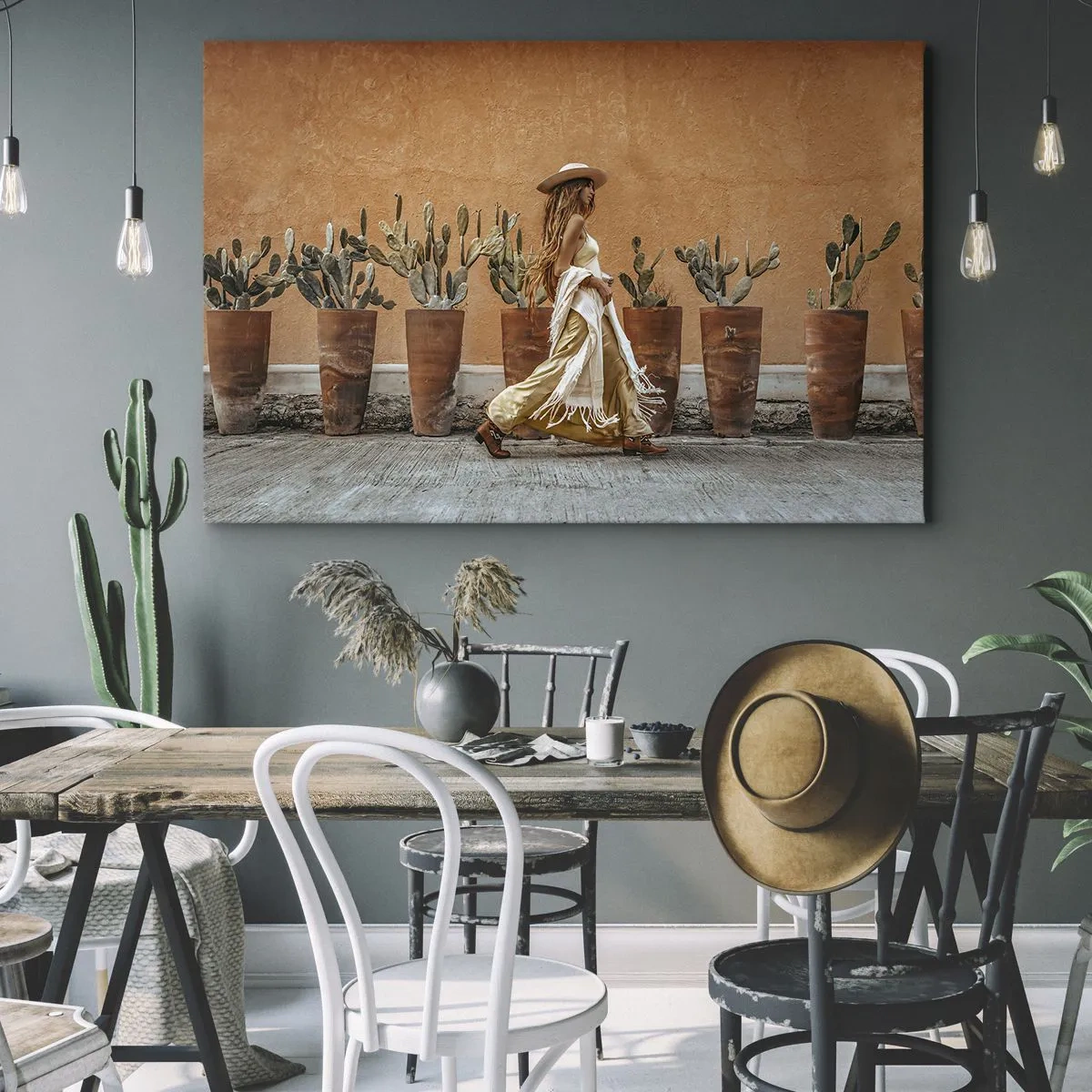 Bild auf Leinwand - Leinwandbild - Eine Frau im Boho-Stil mit Töpfen voller Kakteen im Hintergrund. - 70x50cm - Hippie-Stil - Moderne Wanddekoration für Wohnzimmer und Schlafzimmer ARTTOR