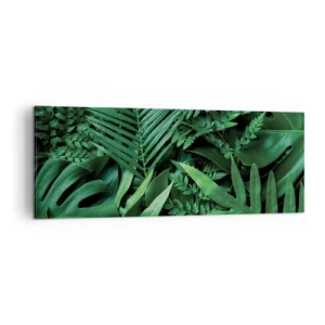 Bild auf Leinwand - Leinwandbild - Grüne tropische Blätter in einer dichten und natürlichen Komposition - 140x50cm - Eingebettet ins Grüne - Moderne Wanddekoration für Wohnzimmer und Schlafzimmer ARTTOR