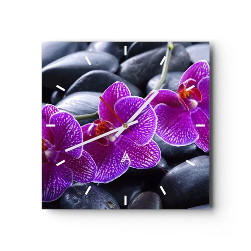 Wanduhr - Glasuhr - Lila Orchideen vor einem Hintergrund aus schwarzen Steinen - 30x30cm - Die Steine 