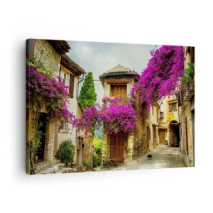 Bild auf Leinwand - Leinwandbild - Eine Steinstraße mit rosa Blumen und Häusern - 70x50cm - Unter einem Blumendach - Moderne Wanddekoration für Wohnzimmer und Schlafzimmer ARTTOR