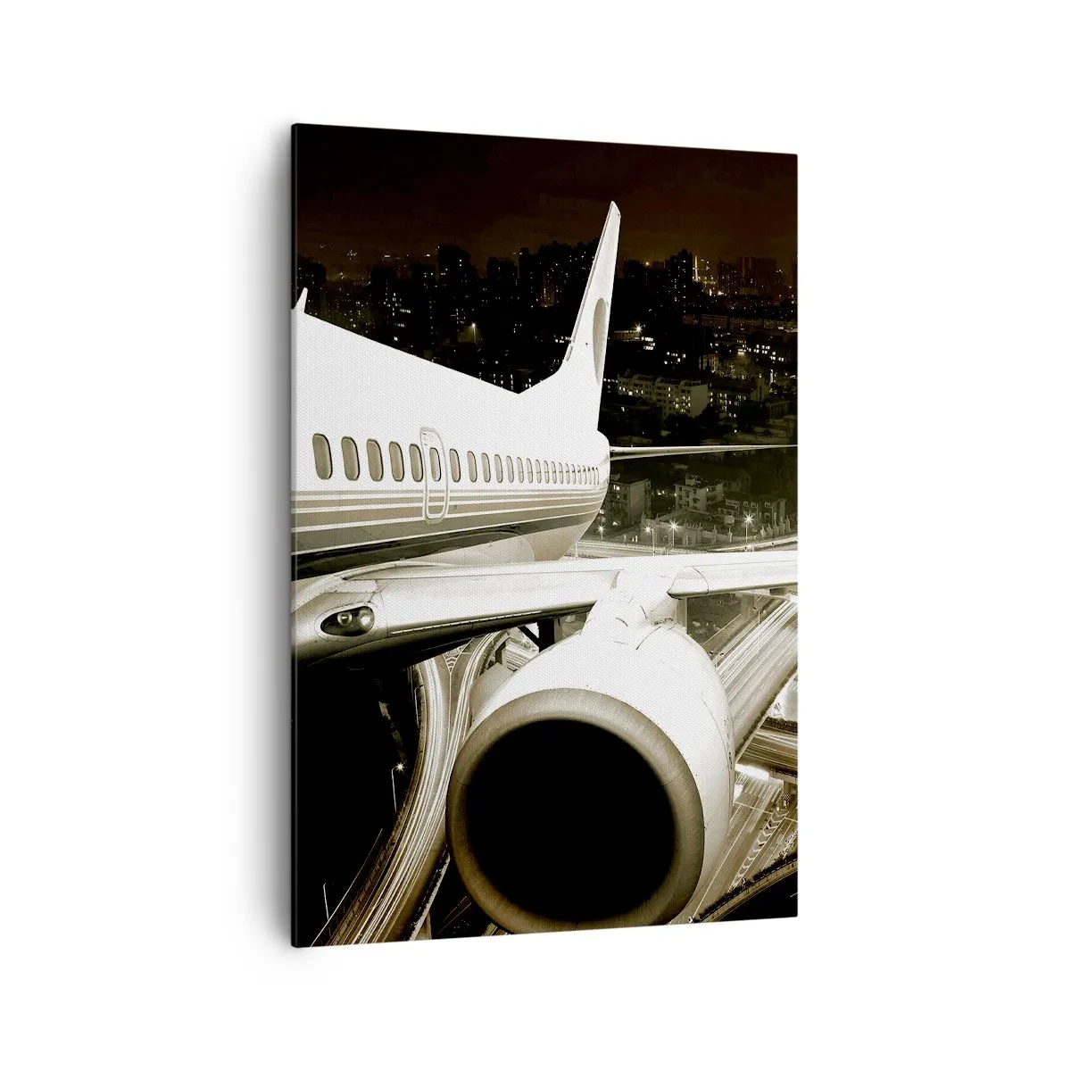 Bild auf Leinwand - Leinwandbild - Ein Flugzeug über einer nächtlichen Stadt mit beleuchteten Autobahnen - 70x100cm - In die Nacht fliegen - Moderne Wanddekoration für Wohnzimmer und Schlafzimmer ARTTOR