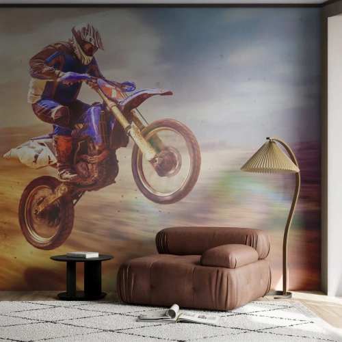 Fototapete Premium Sand - Ein Motorradfahrer in der Luft auf einer Offroad-Strecke in einer dynamischen Aufnahme - 100x70cm - Motorradschwindel - Moderne Wanddekoration für Wohnzimmer und Schlafzimmer ARTTOR