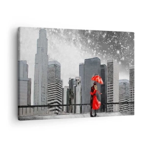 Bild auf Leinwand - Leinwandbild - Ein Paar in Rot mit einem Regenschirm vor dem Hintergrund einer Stadtlandschaft - 70x50cm - Der Mensch ist kein Stein - Moderne Wanddekoration für Wohnzimmer und Schlafzimmer ARTTOR