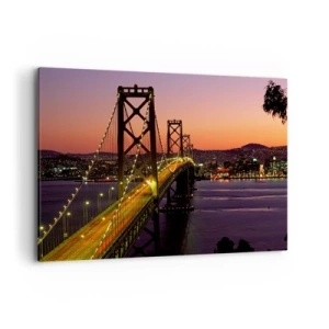 Bild auf Leinwand - Leinwandbild - Eine nachts beleuchtete Brücke über dem Wasser mit Panoramablick auf die Stadt - 100x70cm - Violetter Abend - Moderne Wanddekoration für Wohnzimmer und Schlafzimmer ARTTOR