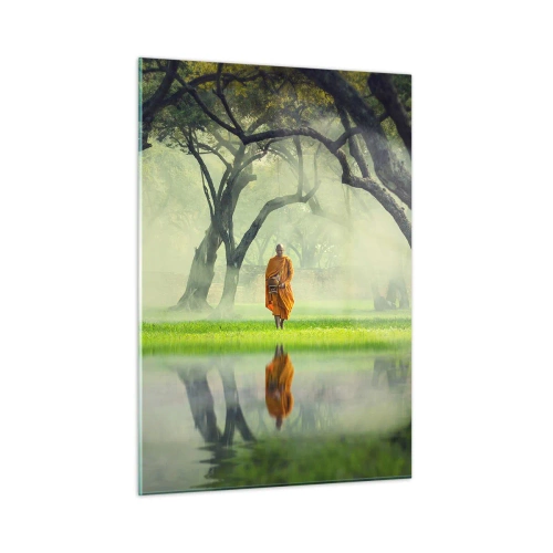 Glasbild - Bild auf glas - Ein Mönch in einer orangefarbenen Robe geht zwischen den Bäumen am Wasser spazieren - 50x70cm - Auf dem Weg zur Erleuchtung - Moderne Wanddekoration für Wohnzimmer und Schlafzimmer ARTTOR