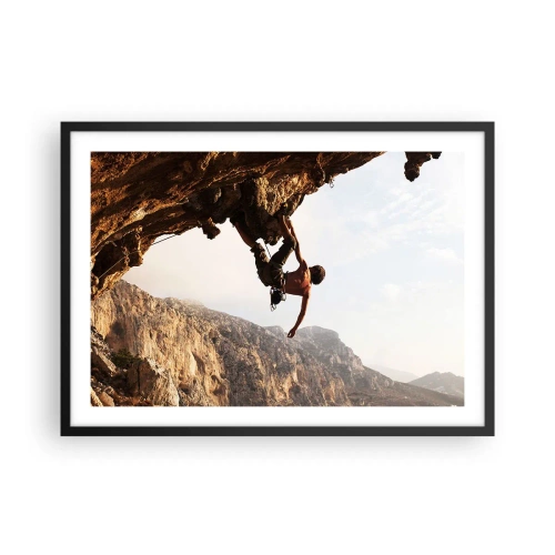 Poster in einem schwarzem Rahmen - Ein Kletterer auf einer steilen Klippe in den Bergen im Sonnenschein - 70x50cm - Die Welt ist in einer Hand auf einem Felsblock geschrumpft - Moderne Wanddekoration für Wohnzimmer und Schlafzimmer ARTTOR