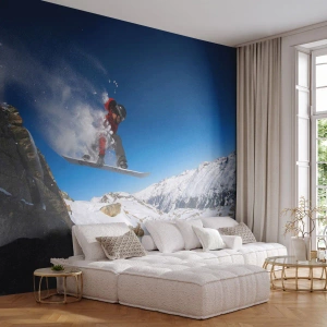 Fototapete Premium Sand - Ein Snowboarder springt vor der Kulisse schneebedeckter Berge. - 100x70cm - Und du wurdest Teil des Raums - Moderne Wanddekoration für Wohnzimmer und Schlafzimmer ARTTOR