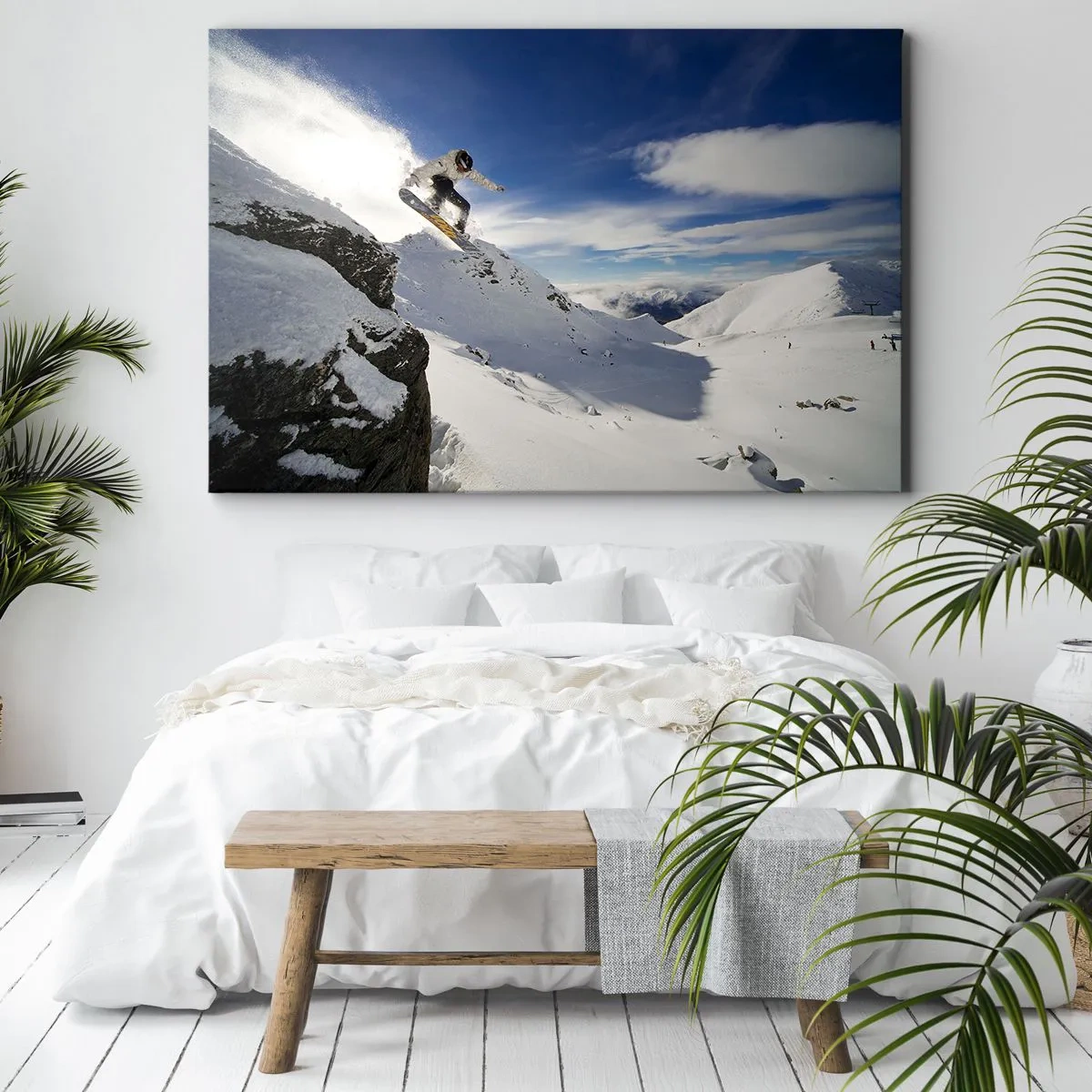 Bild auf Leinwand - Leinwandbild - Ein Snowboarder springt von einer Klippe mit schneebedeckten Bergen im Hintergrund. - 100x70cm - Freiheit ohne Grenzen - Moderne Wanddekoration für Wohnzimmer und Schlafzimmer ARTTOR