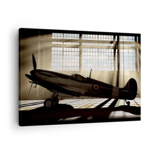 Bild auf Leinwand - Leinwandbild - Ein historisches Flugzeug in einem Hangar, beleuchtet vom Sonnenlicht - 70x50cm - Die Ruhe eines Kriegers - Moderne Wanddekoration für Wohnzimmer und Schlafzimmer ARTTOR
